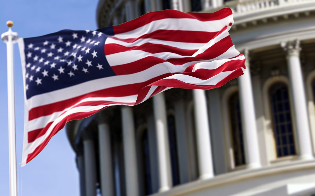 Le drapeau des États-Unis d’Amérique devant le bâtiment du Capitole Le drapeau des États-Unis d'Amérique devant le bâtiment du Capitole
